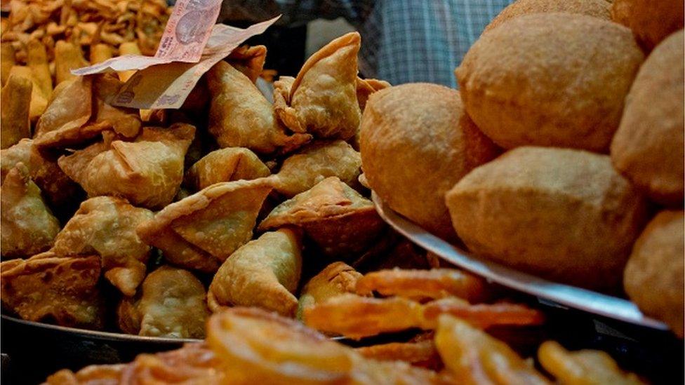 Vendor Arranging Kachories For Sale At Street Market. (Photo by: Madhurima Sil/IndiaPictures/Universal Images Group via Getty Images)