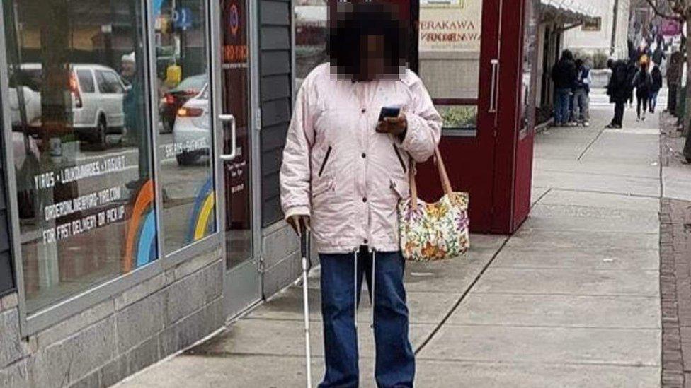 Woman with cane on her phone