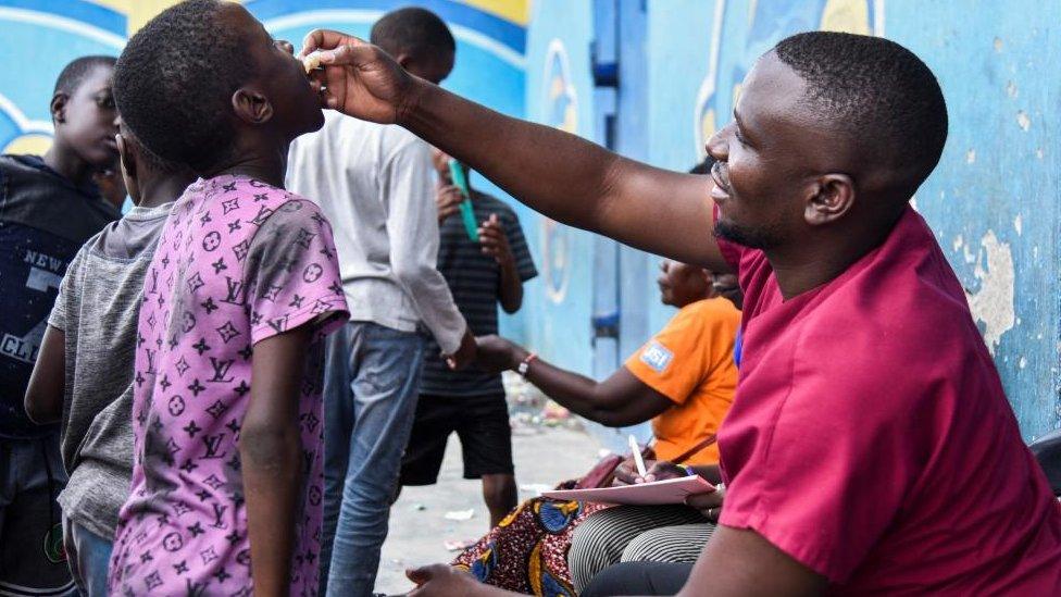 A man administers the cholera vaccine to a child at a temporary cholera treatment centre which has been set up to deal with the latest deadly cholera outbreak, at the Heroes National Stadium in Lusaka, Zambia January 17, 2024