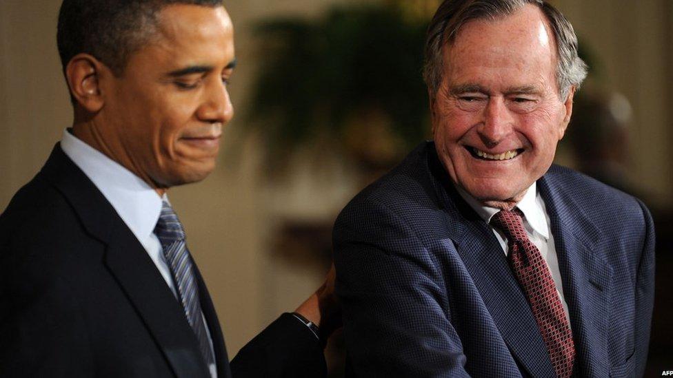 US President Barack Obama presents the 2010 Medal of Freedom to former President George HW Bush in this February 15, 2011