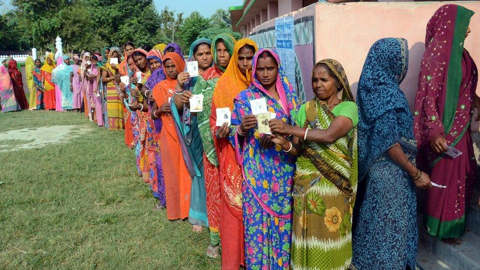 Voters in Bihar queue outside a polling station (file photo - 12 October)