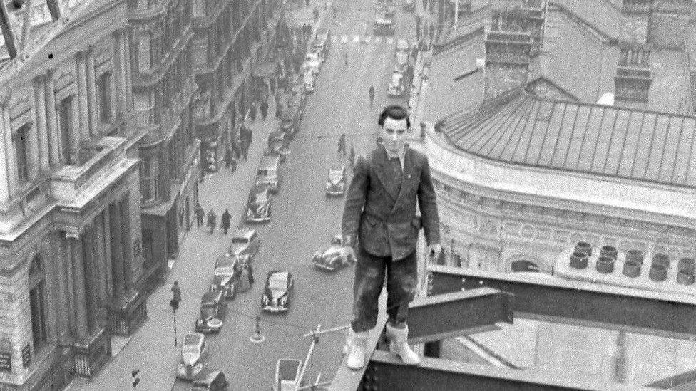 Man stands on scaffolding above Birmingham