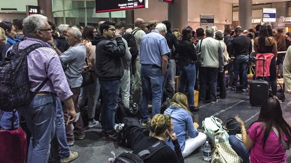 Passengers waiting at the gate for boarding flight to Miami Airport