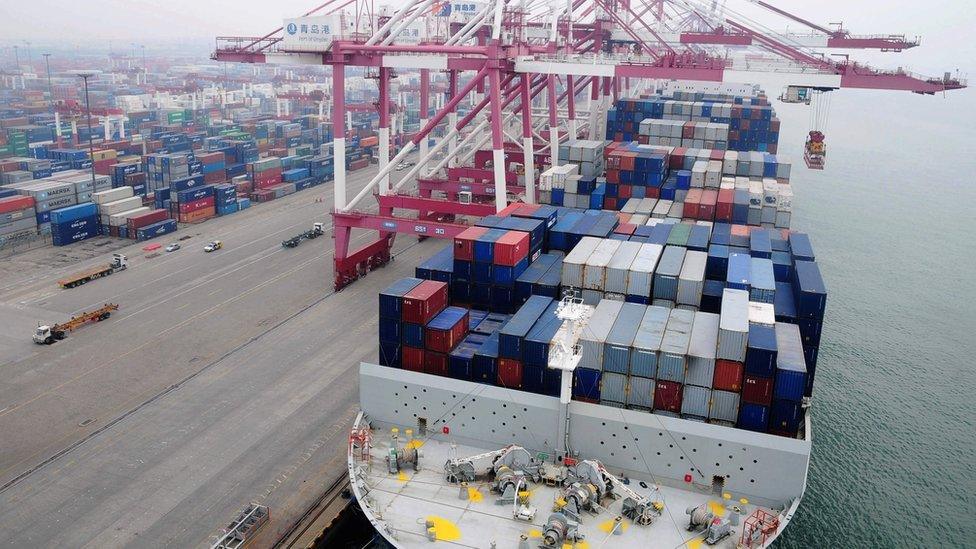 A cargo ship being loaded at a port in eastern China