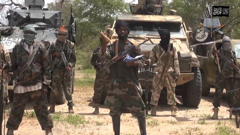 Nigerian Islamist extremist group Boko Haram pictured with the leader of the Nigerian Islamist extremist group Boko Haram, Abubakar Shekau (C).