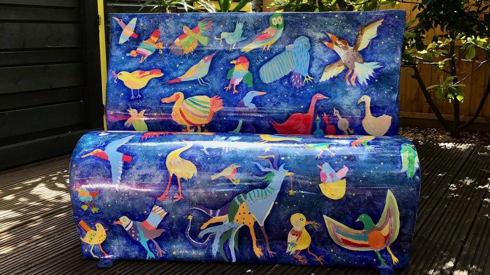 One of the benches decorated with birds