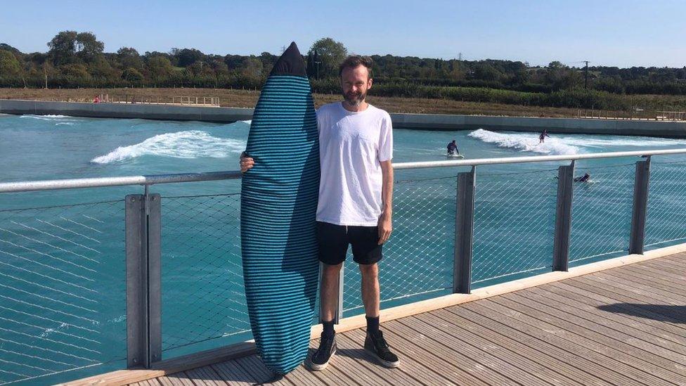 Jamie Monson with his surfboard