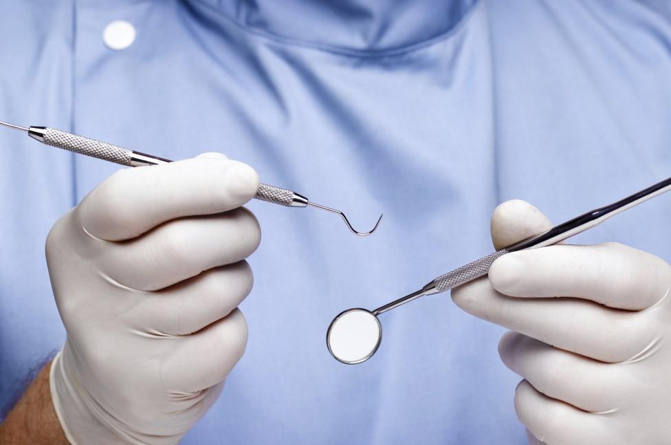 Dentist holding tools.