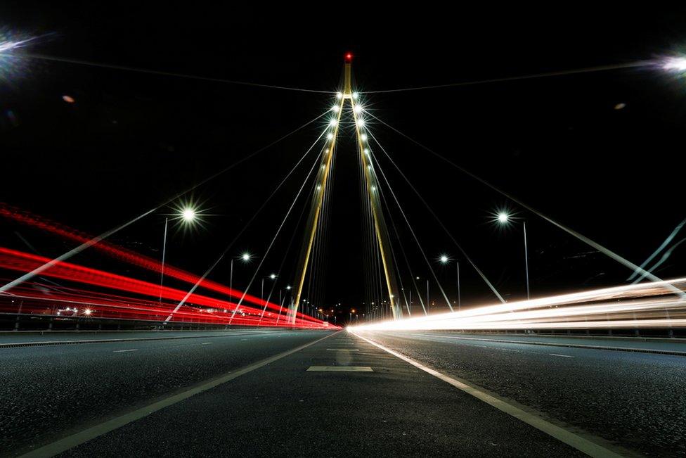 Northern Spire Bridge is illuminated in yellow, as part of a day of reflection to mark the anniversary of Britain's first coronavirus disease (COVID-19) lockdown, in Sunderland