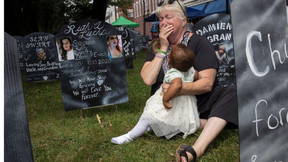 A woman at an event calling for the Sacklers to be prosecuted in 2021