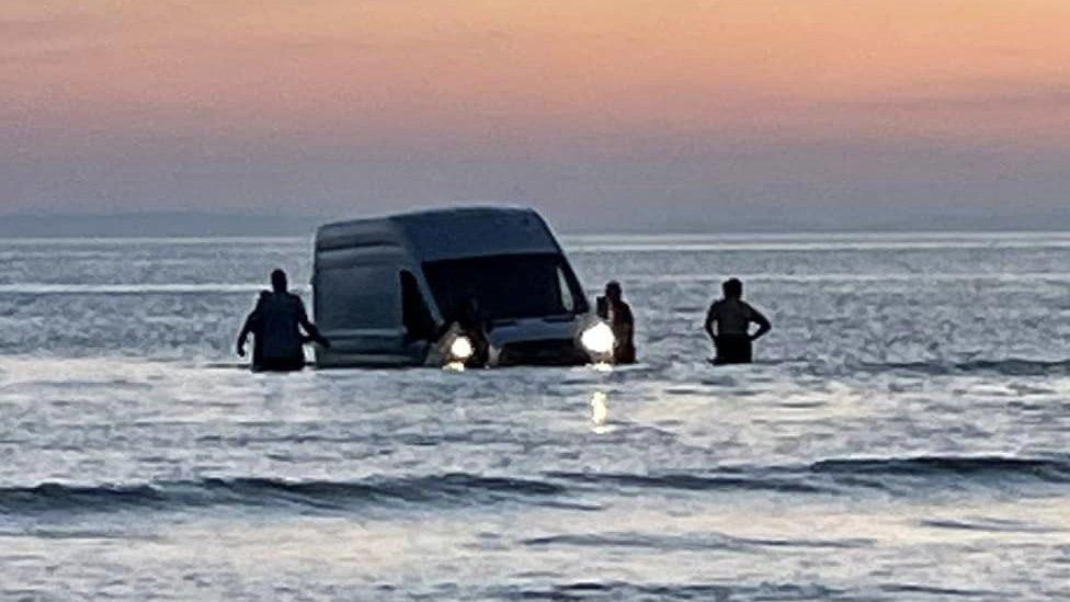 Van submerged Black Rock sands