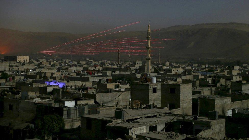 A fire trail is seen during clashes between forces loyal to Syria"s President Bashar al-Assad and the Army of Islam fighters near Damascus, Syria October 1, 2015