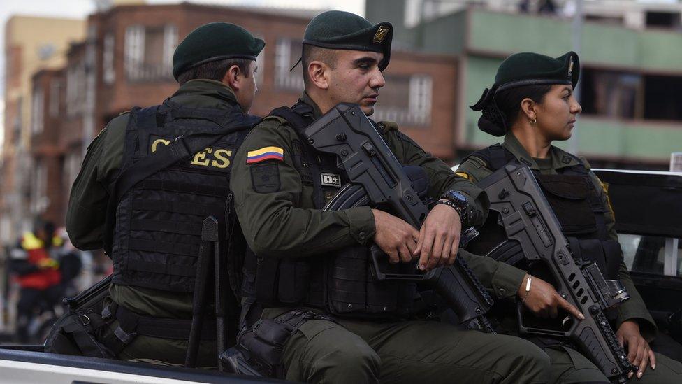 Security forces patrol near the site of an explossion