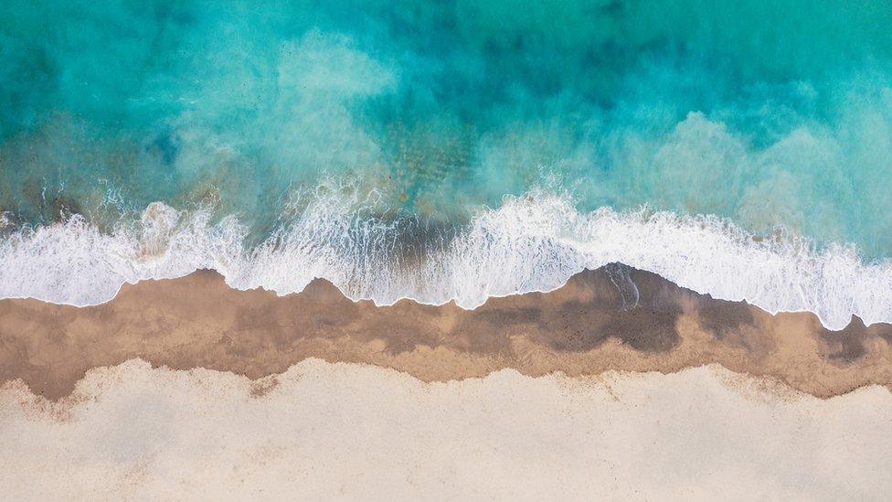 Aerial view of waves breaking on Newquay beach