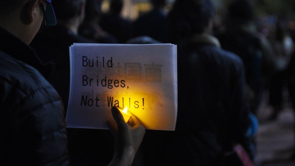 People attend a rally and candlelight vigil in Los Angeles, California