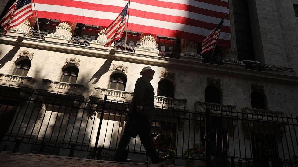 A man walks by the New York Stock Exchange (NYSE) on July 12, 2018 in New York City.