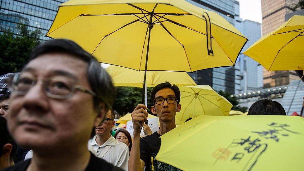 Activists hold yellow umbrellas, a symbol of the pro-democracy movement