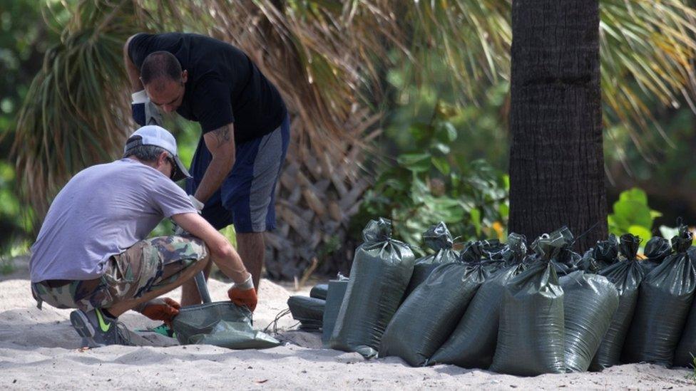 People shovel sand into sandbags in Fort Lauderdale