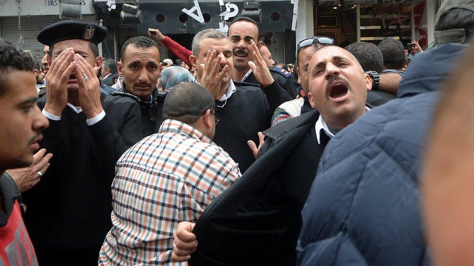 A group of Egyptian police personnel mourn outside the Saint Mark"s coptic Cathedral in Alexandria, 250km northwest of Cairo, Egypt, 09 April 2017