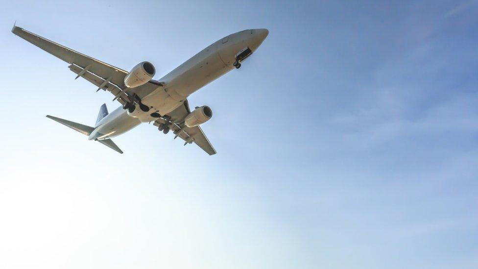 A commercial aeroplane flying in the sky