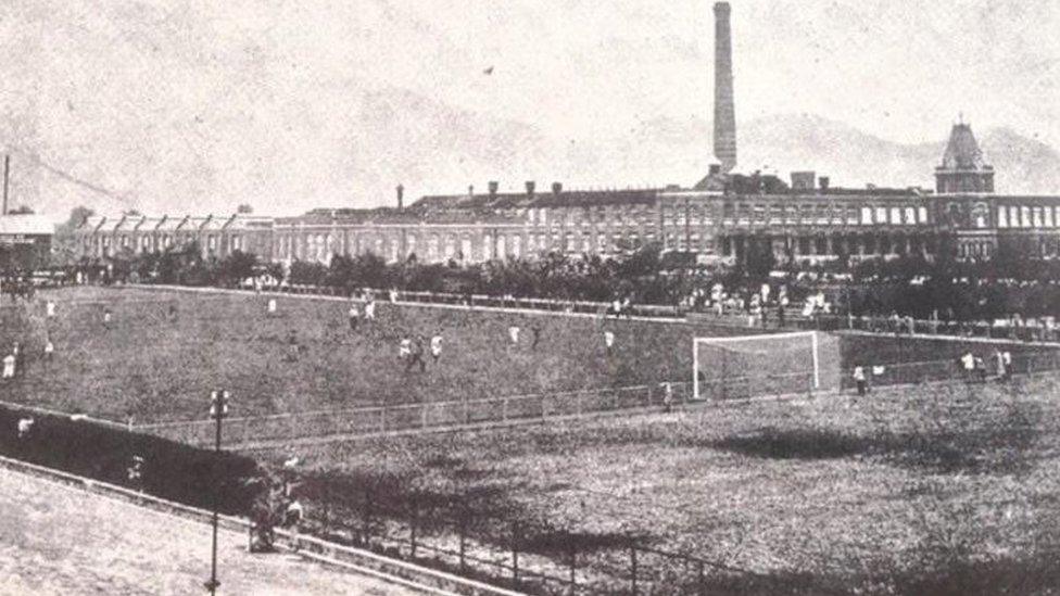 Football pitch beside a factory