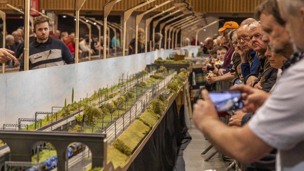 People at a model train exhibition