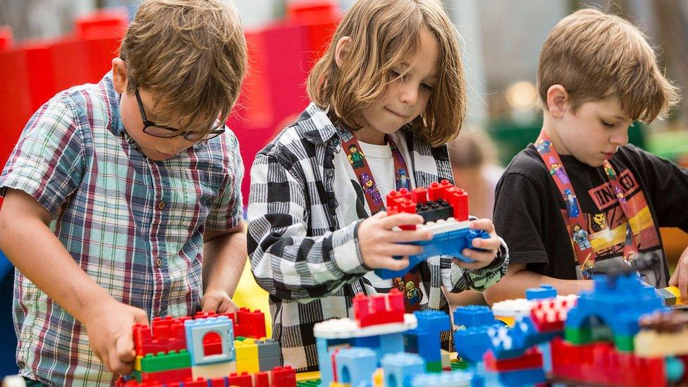 Children playing with plastic bricks