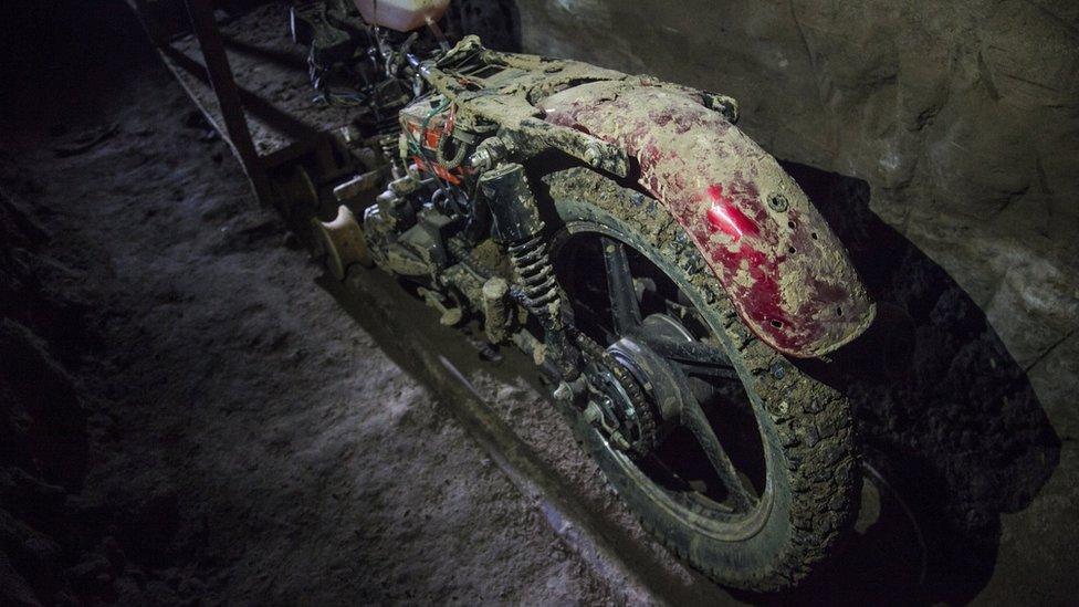 View of a motorcycle adapted to a rail used by Mexican drug trafficker Joaquin "El Chapo" Guzman to move through a tunnel