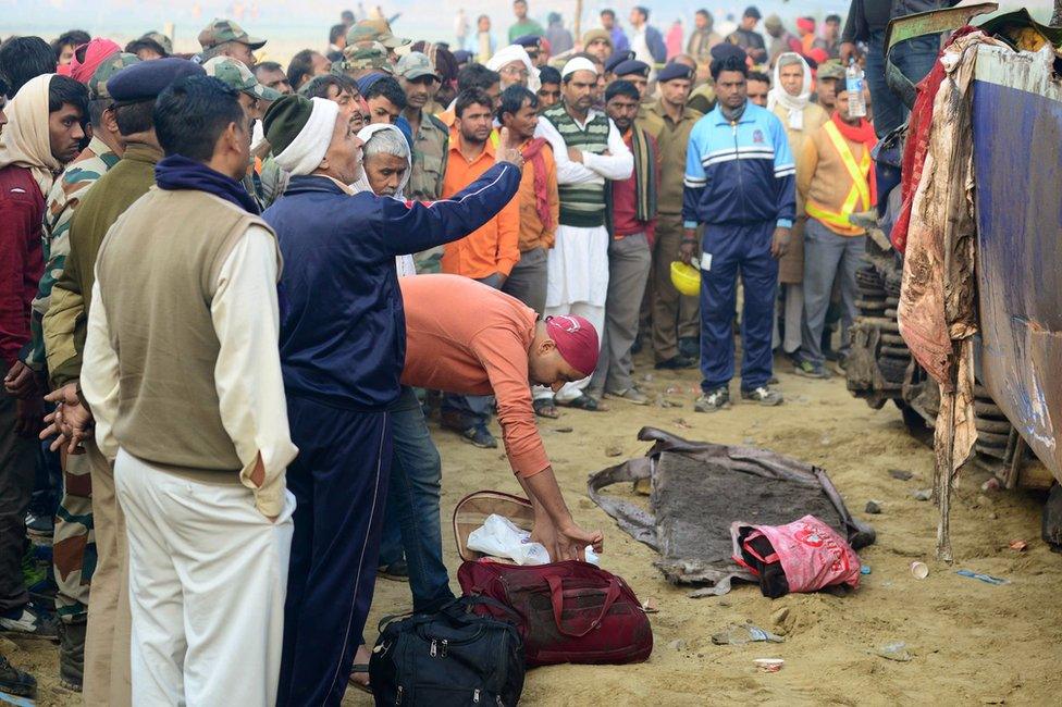 Relatives identify the luggage of a family member who was killed in a train accident in Kanpur on 21 November 2016, after a deadly train derailment.