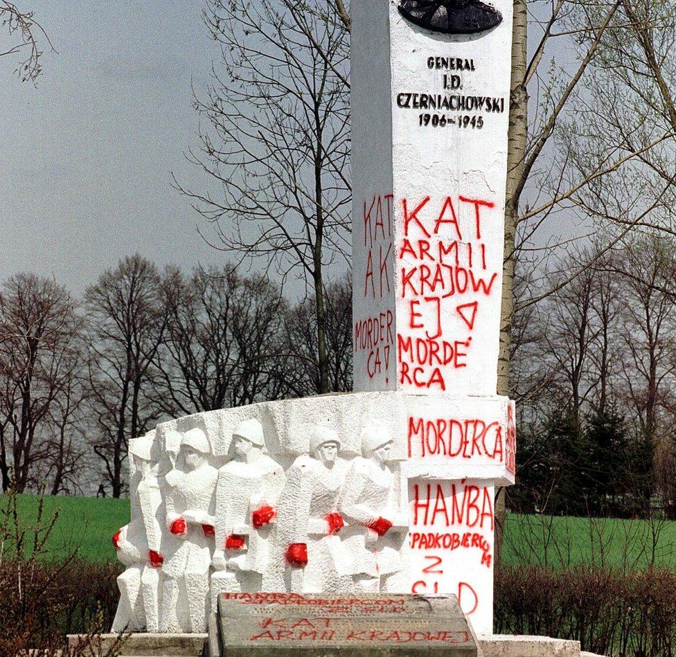 In this file photo from 2001,taken in Pieniezno, Poland, graffiti with insults like "Murderer" and "Shame" can be seen on a memorial to Soviet General Ivan Chernyakhovsky, who is considered a symbol of the imposition of communism in Poland, but a national hero in Russia.