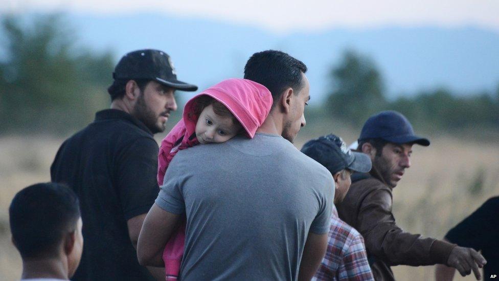 Syrian refugees wait near the border train station of Idomeni, northern Greece, to be allowed by the Macedonian police to cross the border from Greece to Macedonia on Tuesday, 18 August 2015