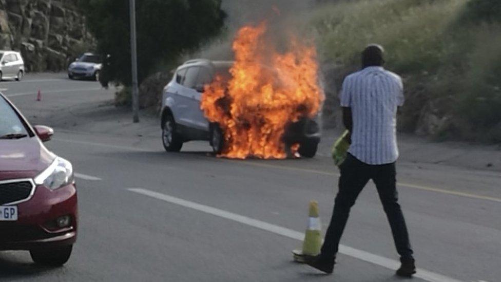 In this photo taken Thursday, Jan. 12, 2017 the 2013 Ford Kuga owned by Warren Krog burns out in Alberton Johannesburg