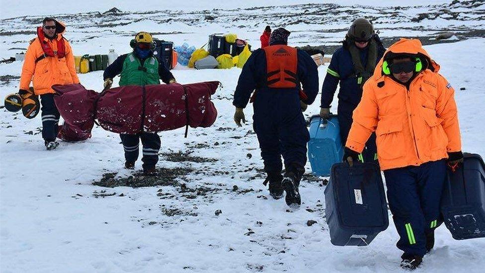 A photo published by the Argentine Foreign Ministry shows Argentine Navy personnel helping US scientists load their equipment