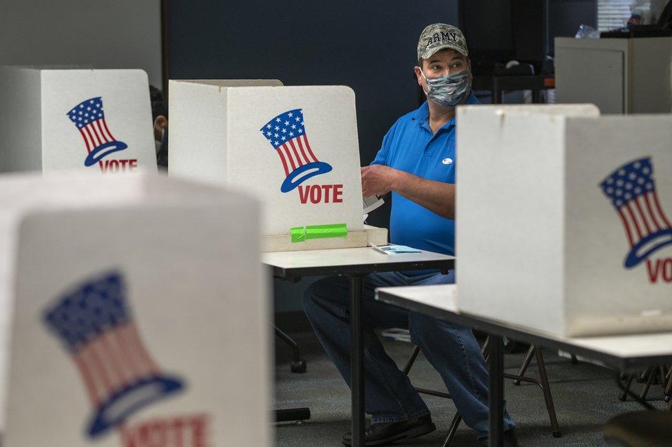 A voter in a voting booth