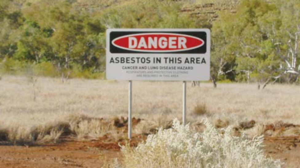 A warning sign around Wittenoom which reads: Danger. Asbestos in this area. Cancer and Lung disease hazard