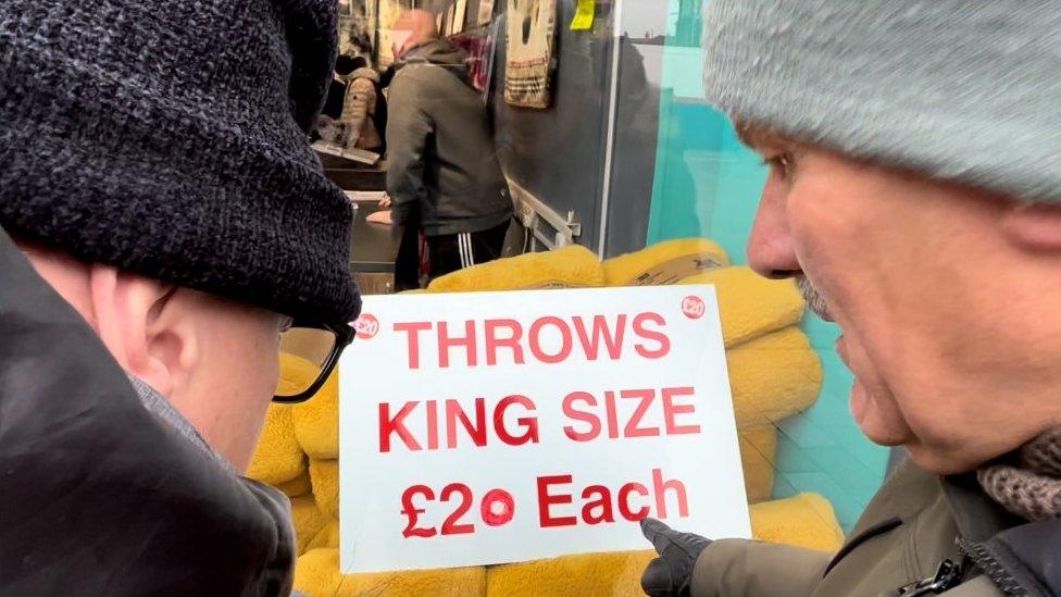 Graham reads a sign outside a Hull city centre shop