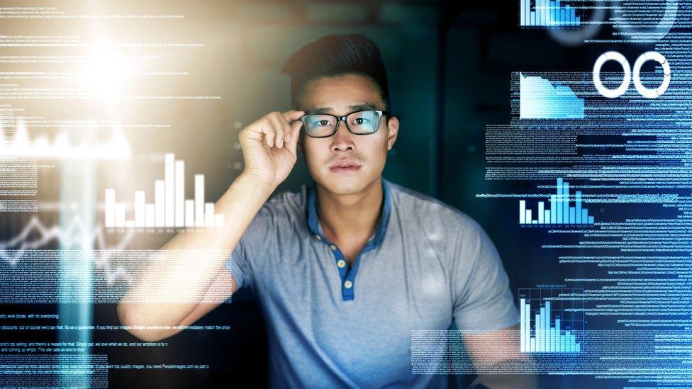 Man surrounded by digital screens