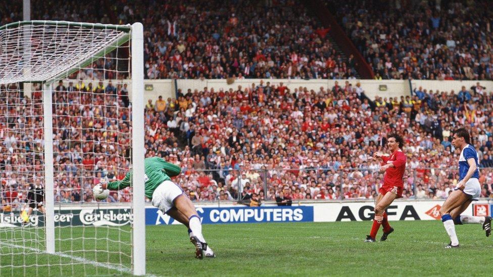 Everton defender Pat Van Den Hauwe looks on as Liverpool player Craig Johnston (c) scores the second goal past Everton goalkeeper Bobby Mimms during the 1986 FA Cup Final on May 10th, 1986