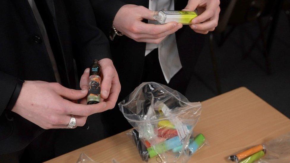 School pupil holding vapes