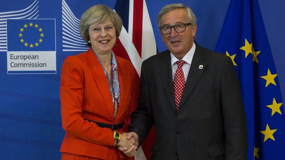 File photo from October 2016 showing Theresa May and Jean Claude Juncker shaking hands.