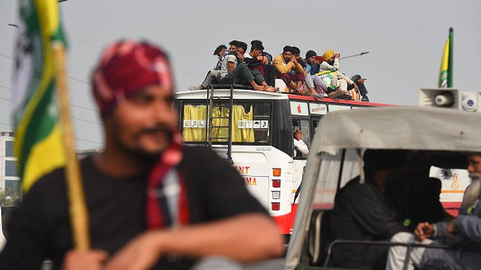 Farmers seen atop a bus during the ongoing protest against the new farm laws at Ghazipur (Delhi-UP border) on February 2, 2021 in New Delhi, India.