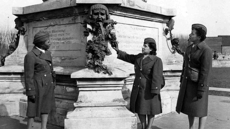 Members of the 6888th battalion posed with the statue of Shakespeare in Stratford upon Avon