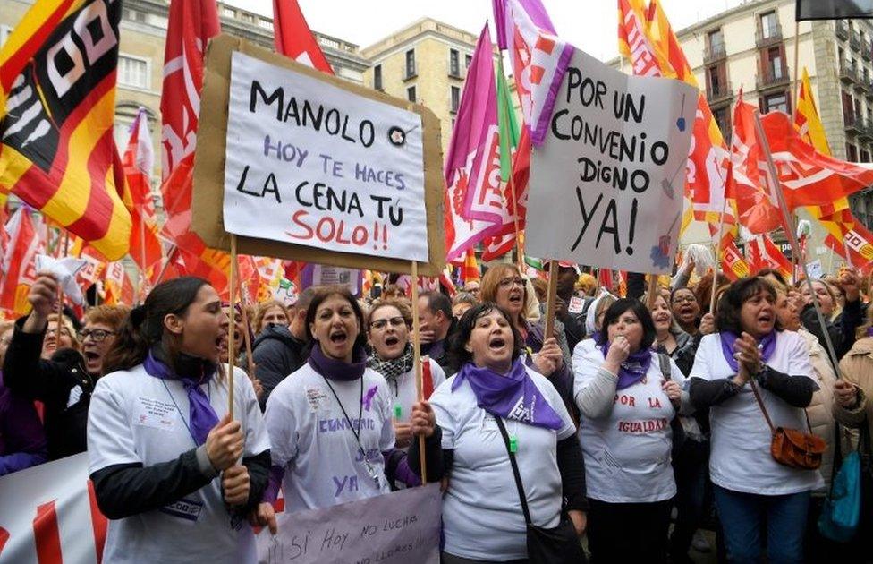 Protesters hold a placard that reads "Manolo, today you'll do your dinner yourself!!" in Barcelona, Spain