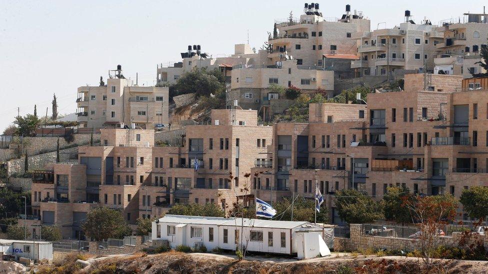 Buildings forming part of Nof Zion, a Jewish settlement in occupied East Jerusalem, are seen in the foreground as buildings from the Palestinian district of Jabal Mukaber are seen in the background (25 October 2017)