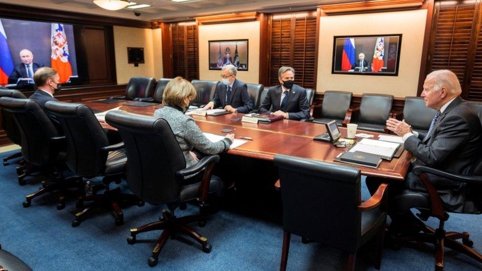 Mr Biden (R) with top officials