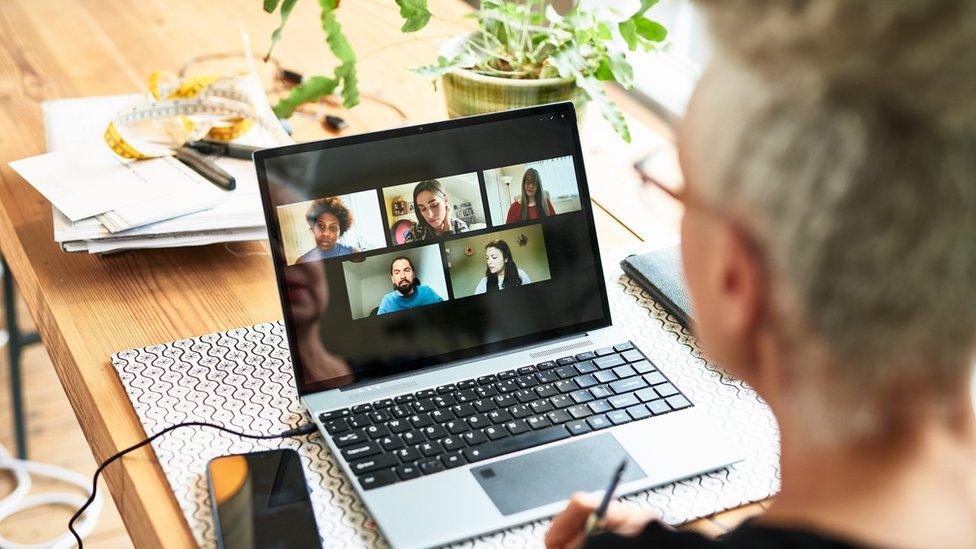 Business owner discussing ideas with colleagues on video call