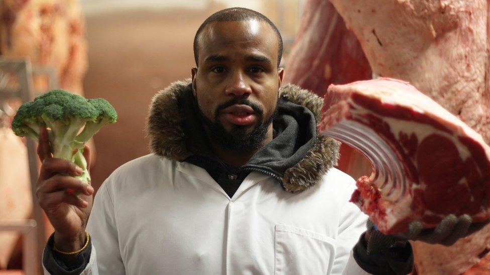 Newsbeat reporter Nesta standing with some broccoli and meat