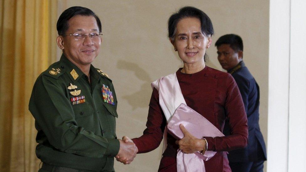 Senior General Min Aung Hlaing, Myanmar"s commander-in-chief, shakes hands with National League for Democracy (NLD) party leader Aung San Suu Kyi before their meeting in Hlaing"s office at Naypyitaw