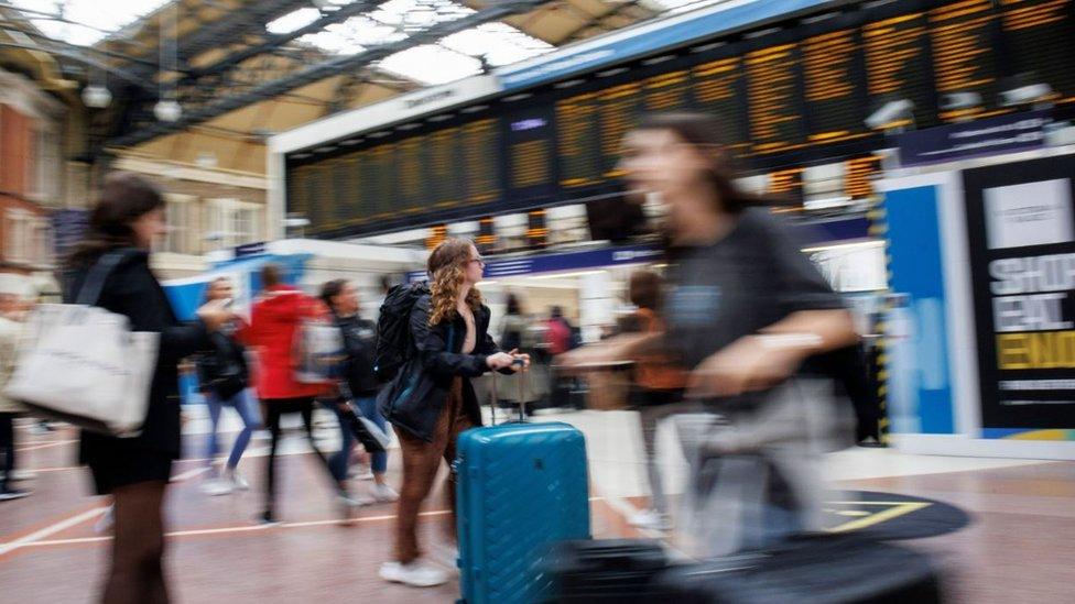 Passengers wait for train services at Victoria Station