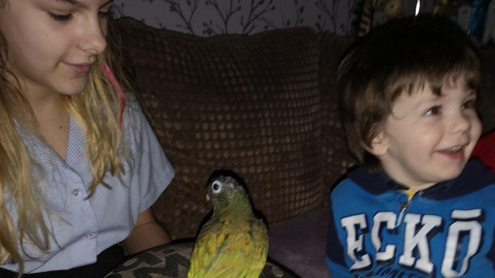 two children and a parrot